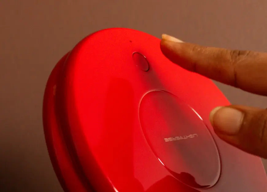 Close up of push switch on Gharko Frisbee Retractable Lamp for stepless dimming and colour change.