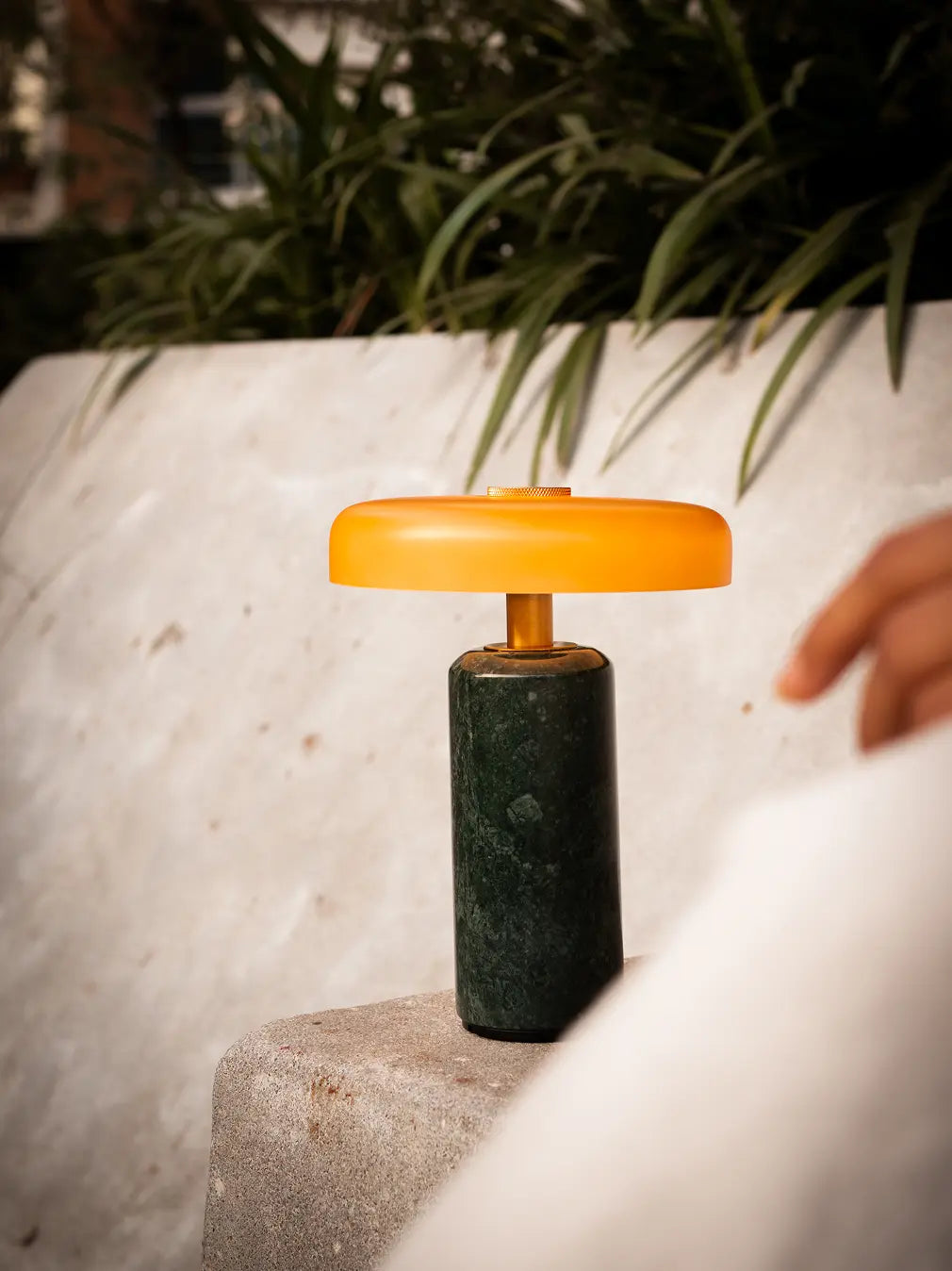 Alba Moss Marble Table Lamp placed outdoors showcasing its portable cordless design