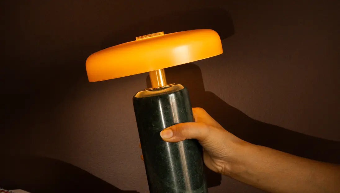 Hand holding the Alba Moss Marble Table Lamp, highlighting its green marble base