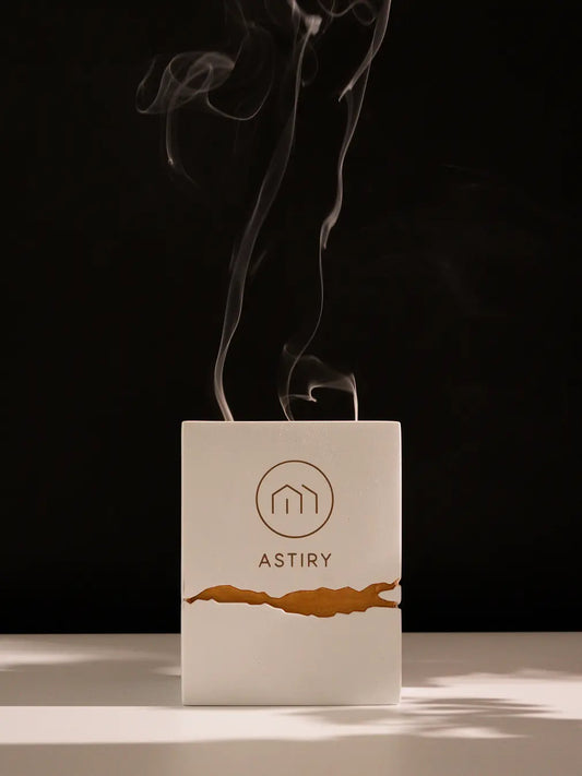 Astiry Concrete Scented Candle emitting delicate smoke after burning, against a dark aesthetic background.