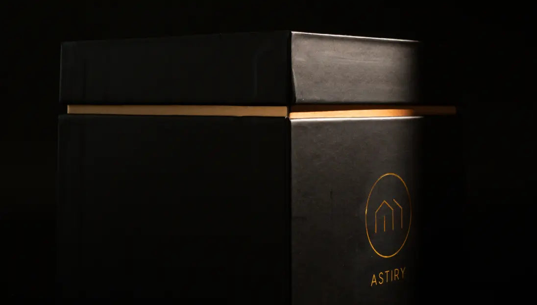 Astiry Concrete Scented Candle’s black packaging with gold detailing, highlighting its premium aesthetic.