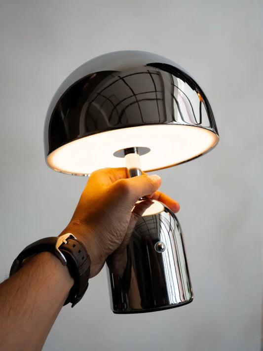 Bell Portable Table Lamp chrome LED with touch dimming in hand