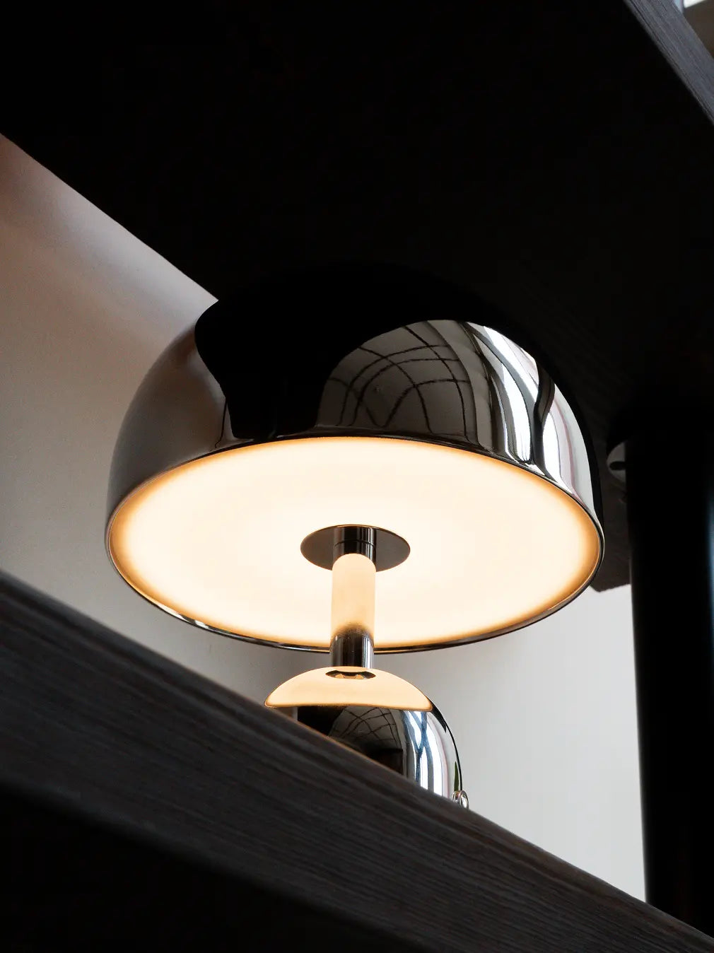 Close-up of Bell chrome table lamp with warm 3000K LED lighting
