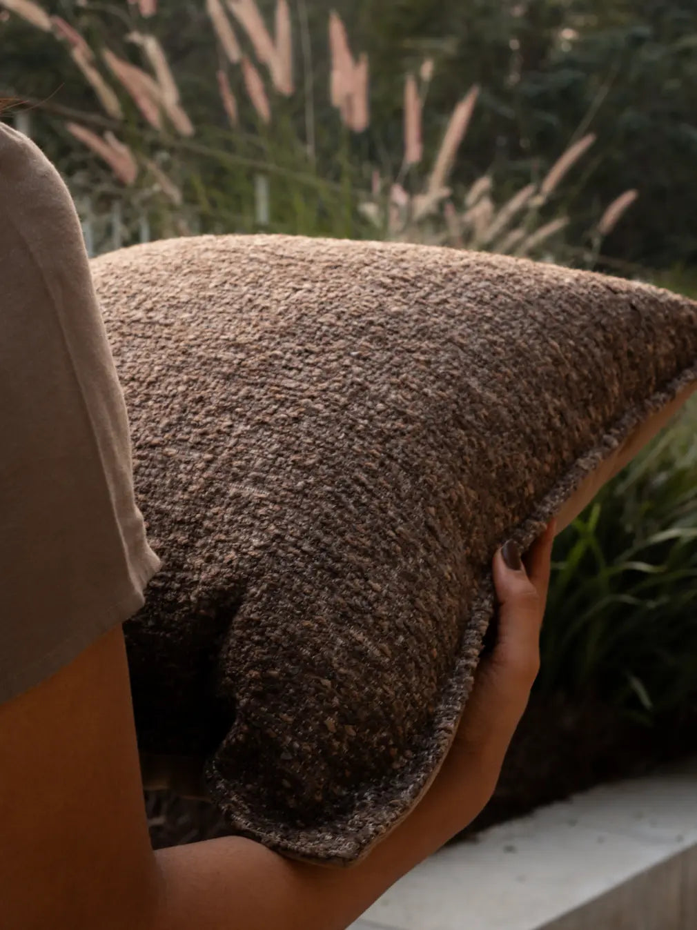 Close-up of boucle cushion cover highlighting dense woven texture and soft finish