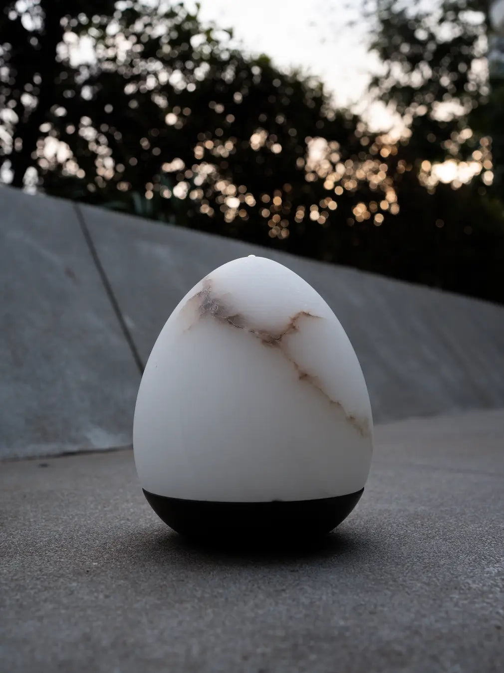 Unlit Bud Marble Portable Table Lamp showing white marble veining and black metal base