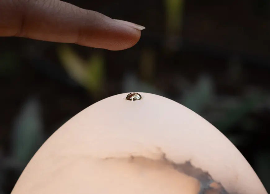 Touch switch on top of the glowing Bud Marble Portable Table Lamp