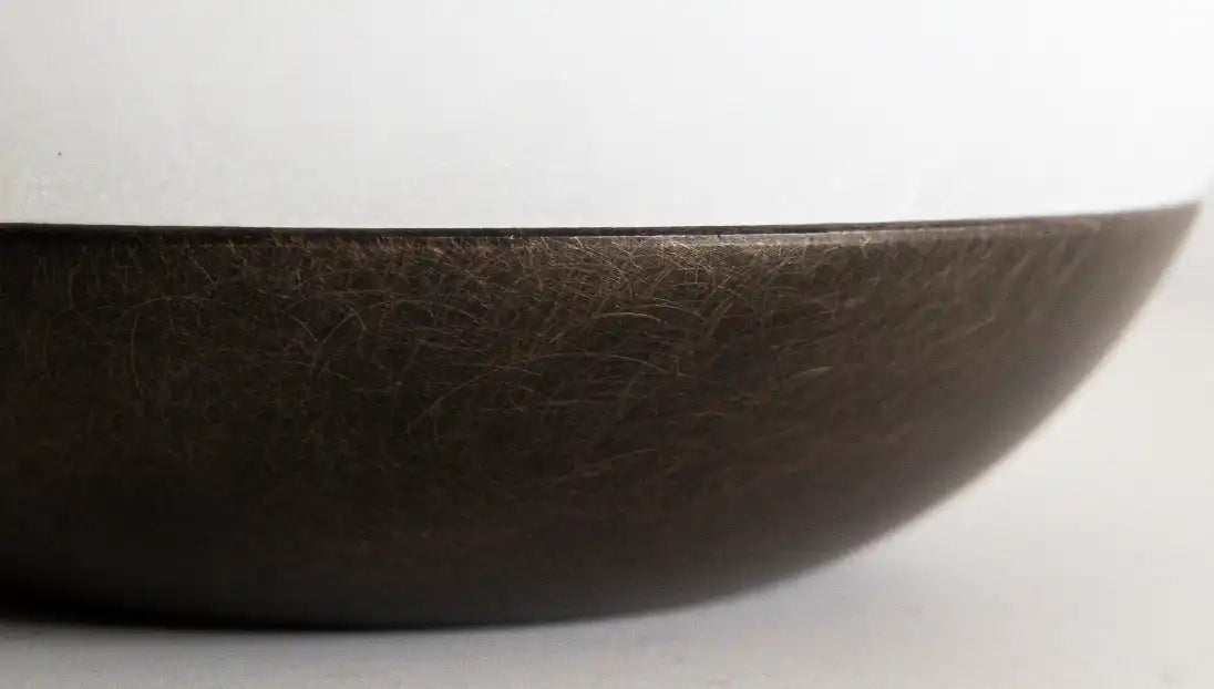 Close-up of the textured dark metal base on Bud Marble Portable Table Lamp