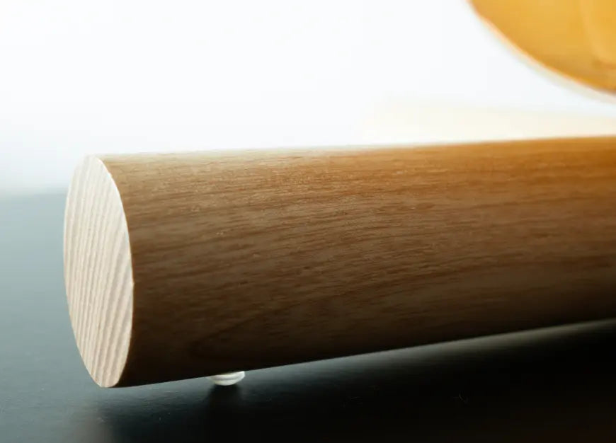 Close-up of a wooden base of Campfire Glass Table Lamp on a wooden surface