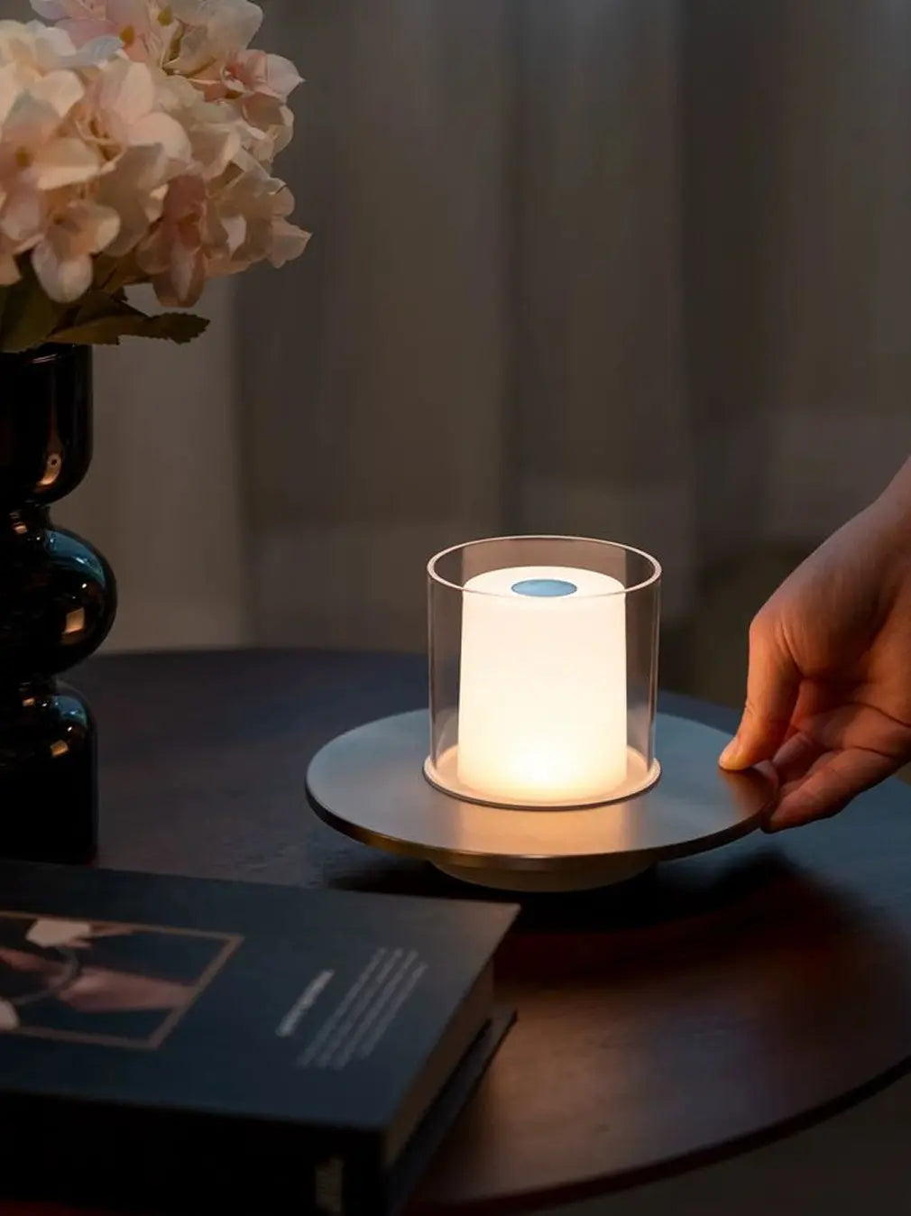 Rechargeable candle table lamp with soft glow on bedside table setup
