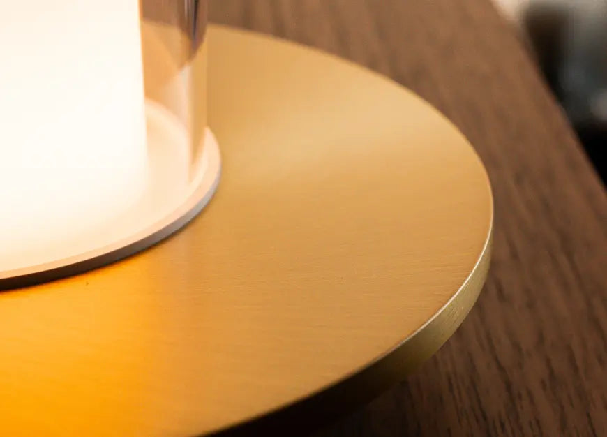 Close-up of gold metal base portable table lamp with premium brushed finish