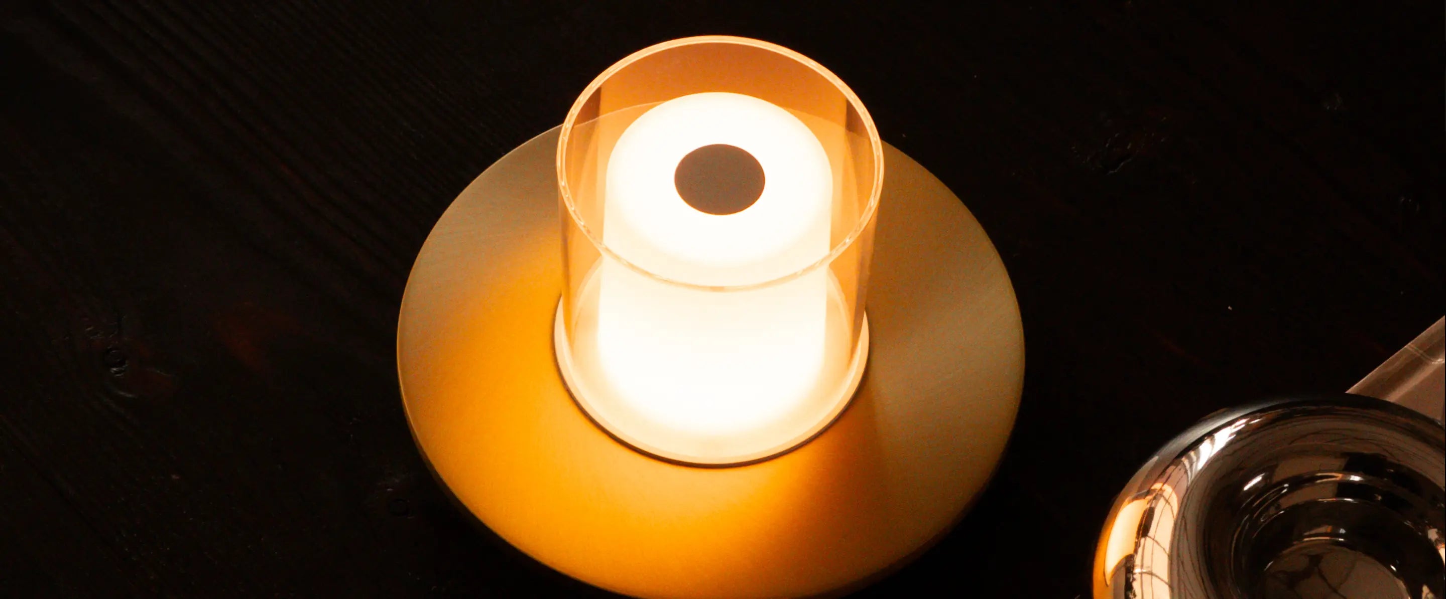 Top view candle-style portable table lamp with gold base and warm LED light