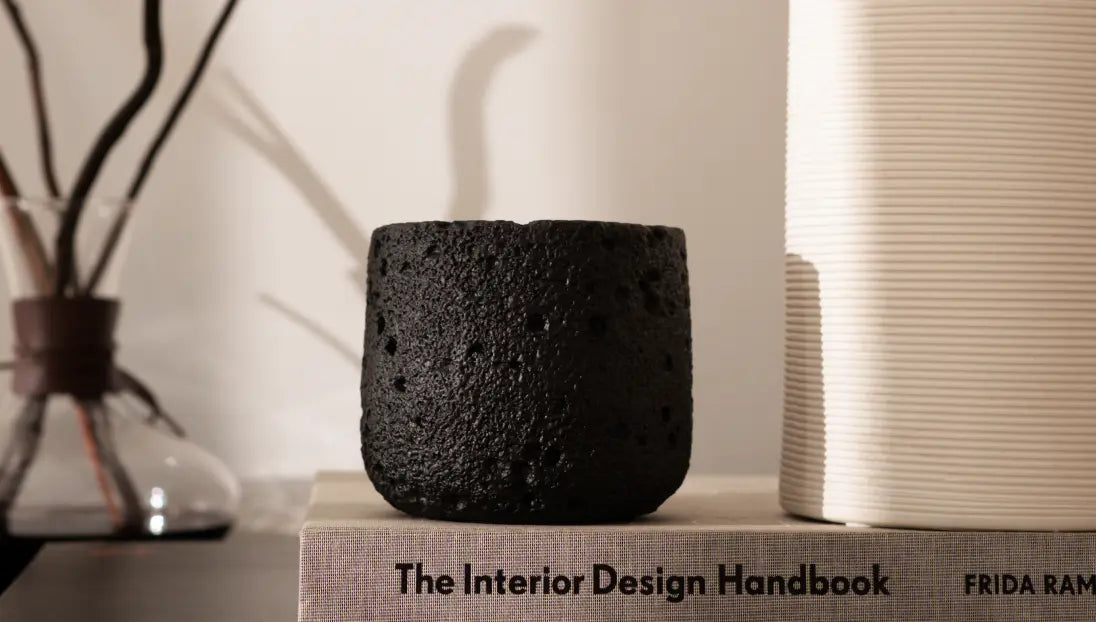 Capri black concrete candle styled on design book