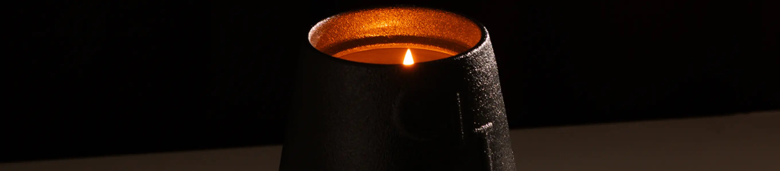 Matte black candle holder with warm flame, perfect for cozy Christmas gift.