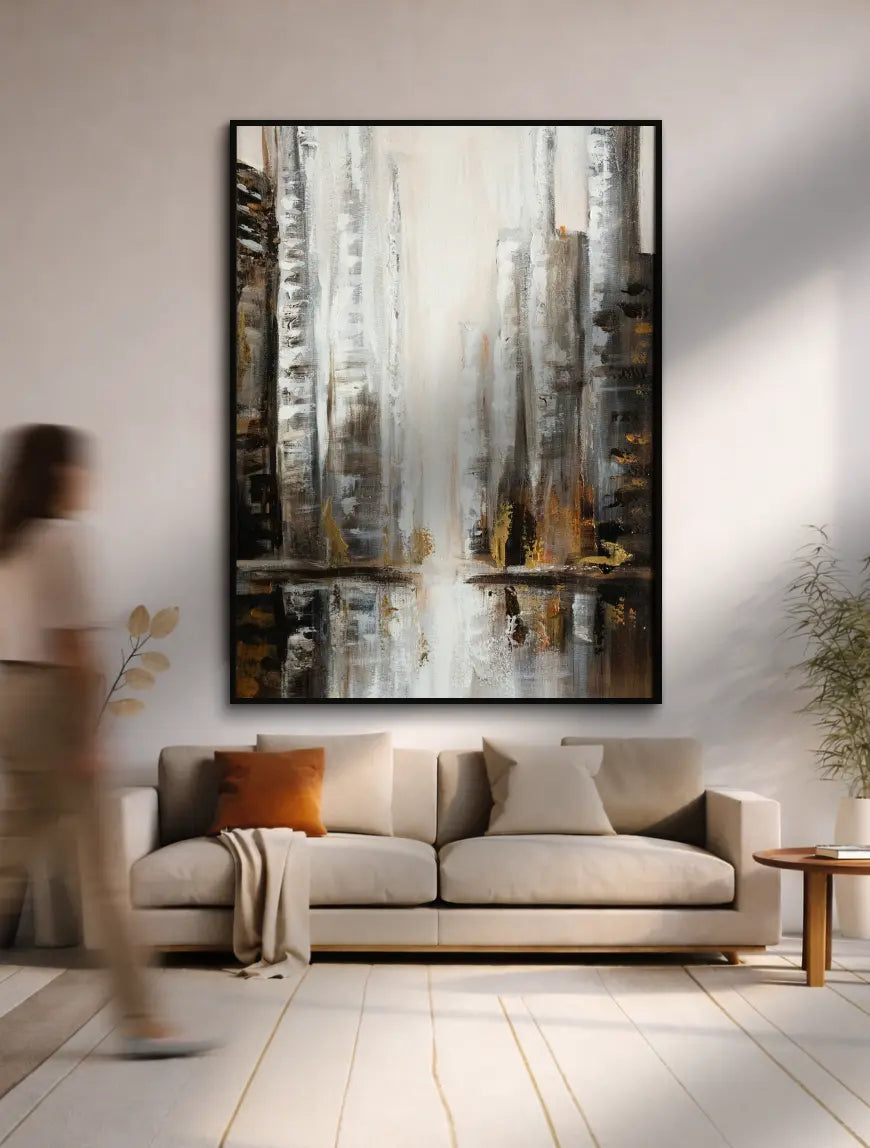 Vertical cityscape abstract wall painting displayed above sofa in a bright interior