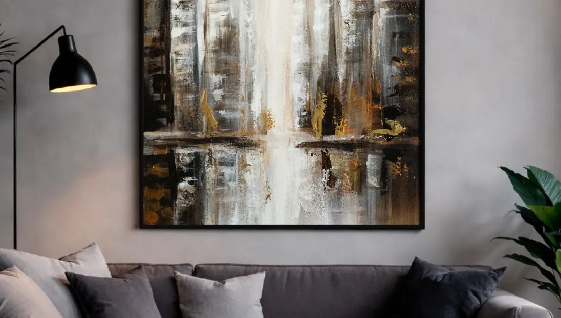 Modern abstract cityscape wall art framed above couch with soft ambient lighting