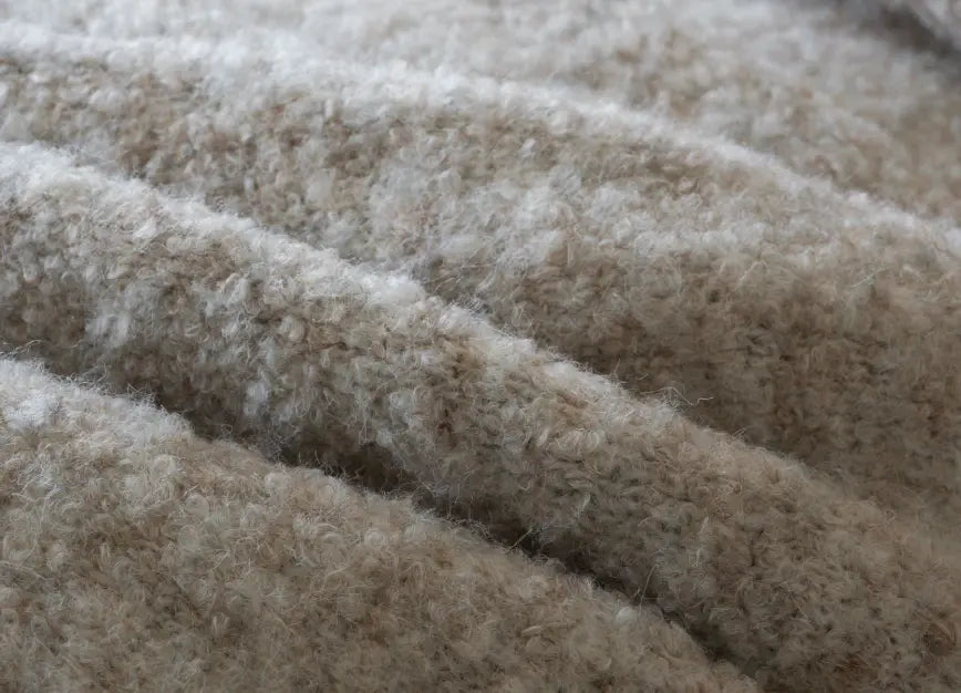 Close-up of plush wool throw fabric showing soft texture and breathable warmth