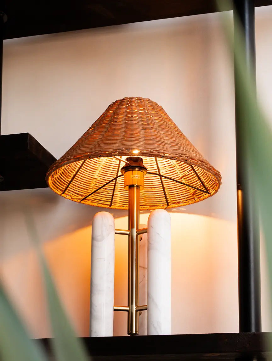Designer Table Lamp with a bamboo rattan lampshade on a blurred background
