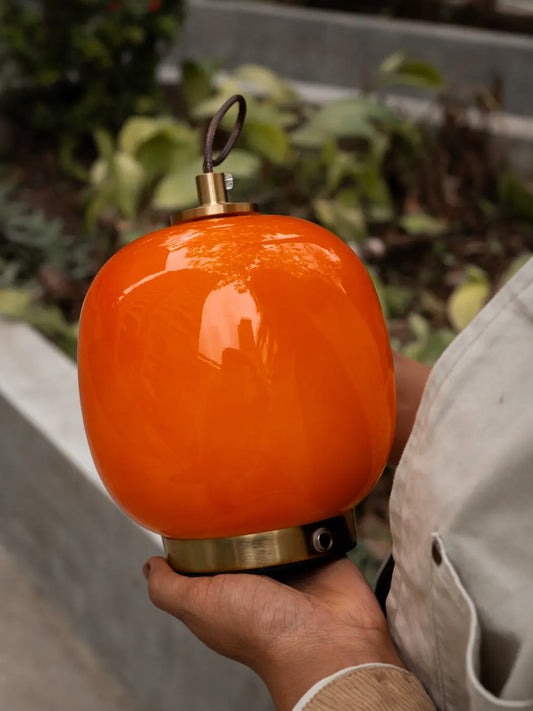 Orange Dew glass portable table lamp with leather strap and gold metal base