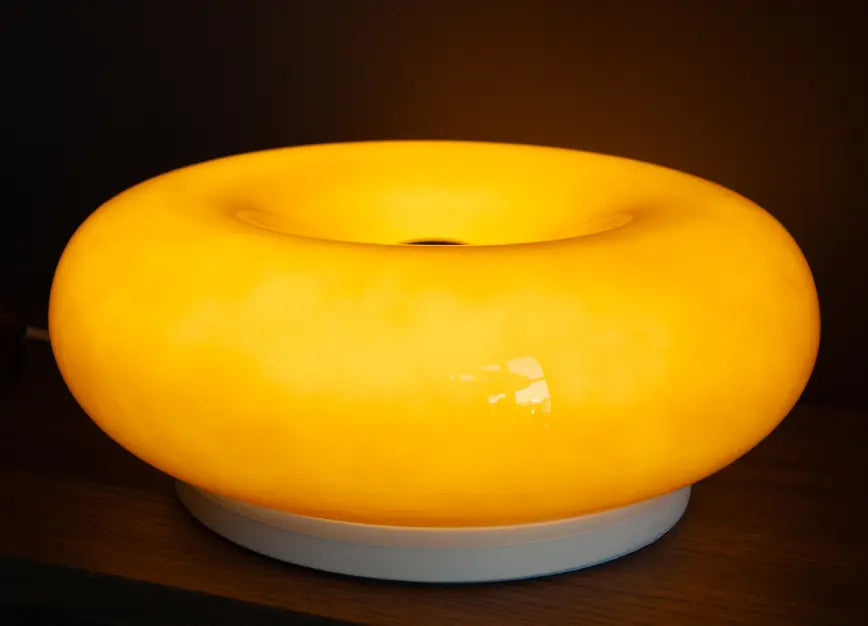 Orange lamp on shelf with a dark background