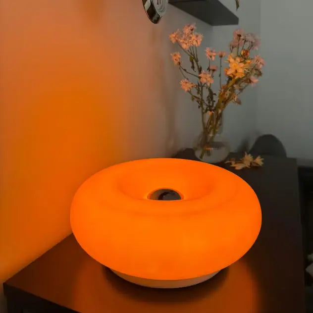 Orange light lamp on a table with a blurred background
