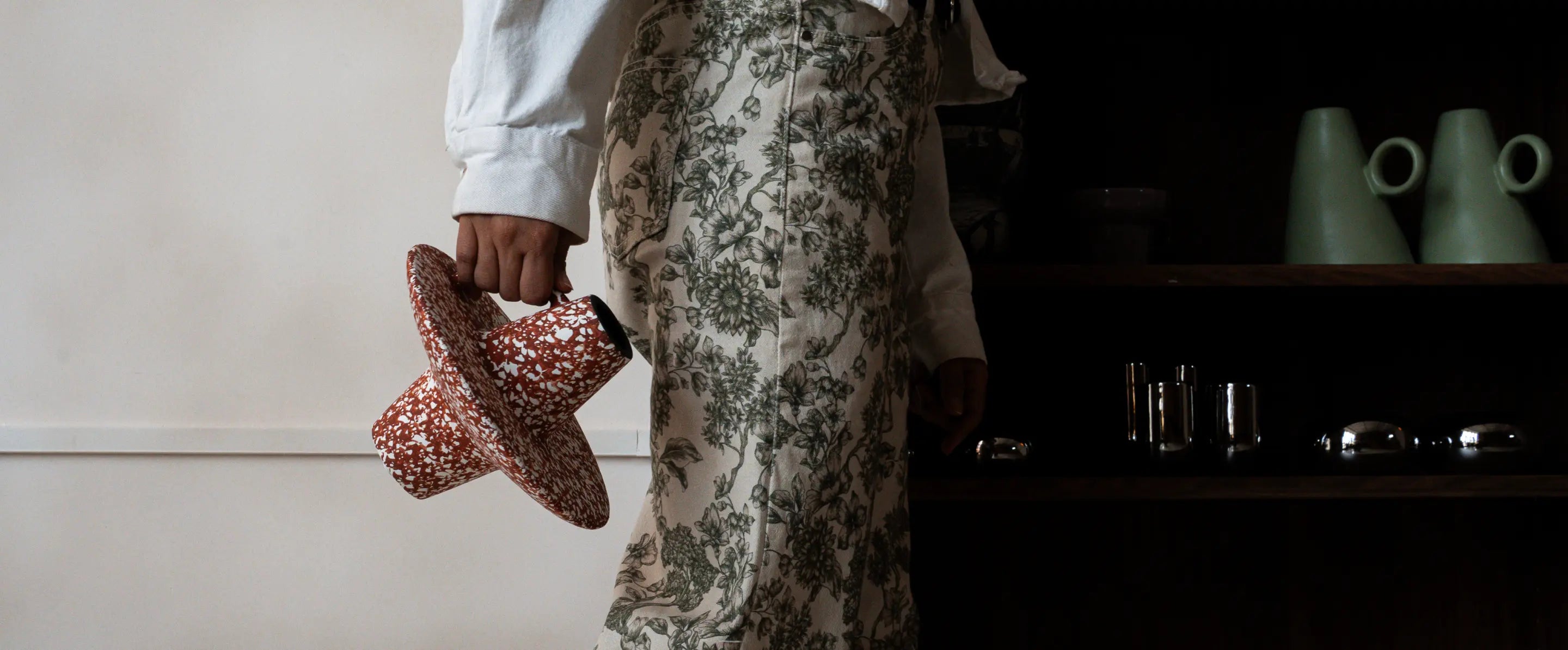 Wide view of bohemian ceramic vase styled in modern home interior