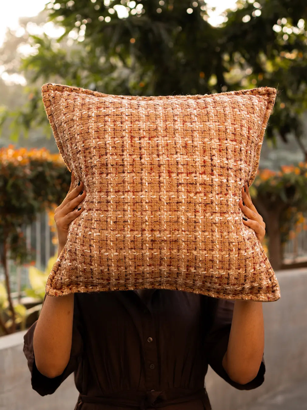 Fleck cushion cover in warm brown jacquard texture, styled for modern living spaces.