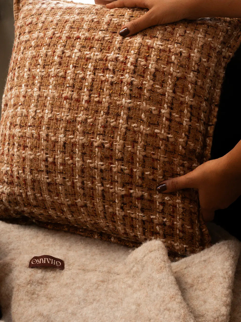 Close-up of Fleck cushion cover showing rich woven texture and earthy tones.