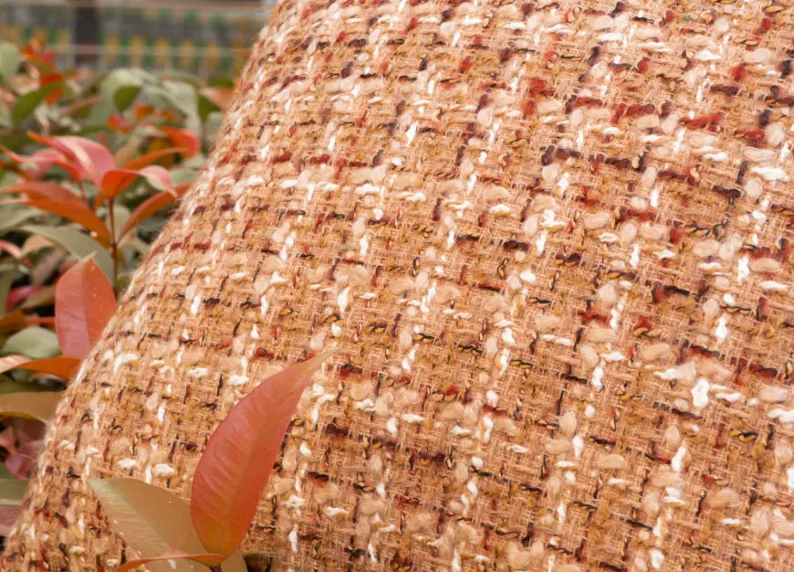 Close-up of Fleck cushion cover highlighting textured jacquard weave detail.