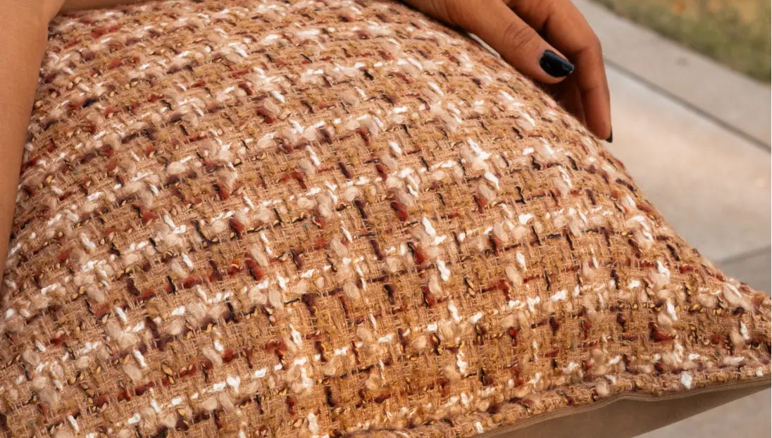 Detailed view of Fleck cushion cover texture with soft woven pattern.