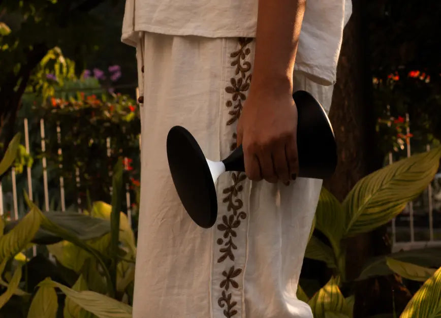 Black Flux Portable Table Lamp being carried outdoors, showing portable design.