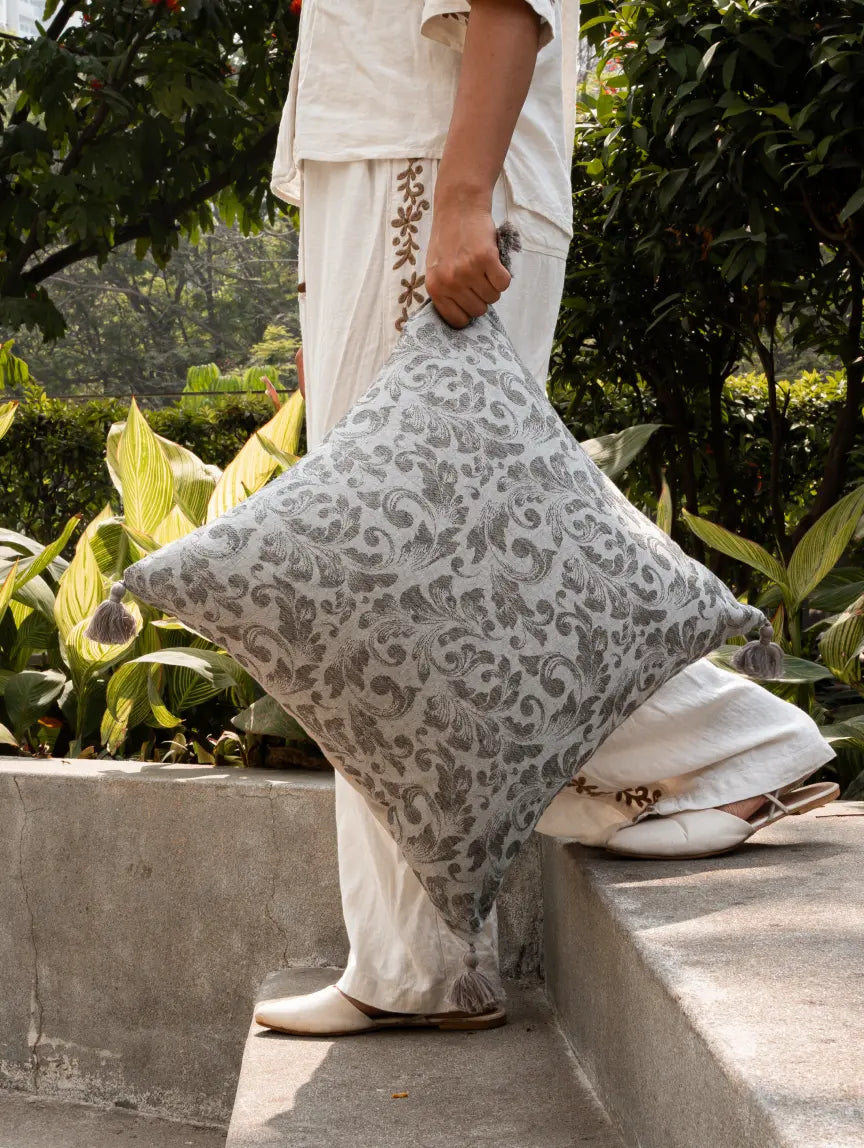 Folia square cushion cover with tassels styled outdoors in modern home decor setting