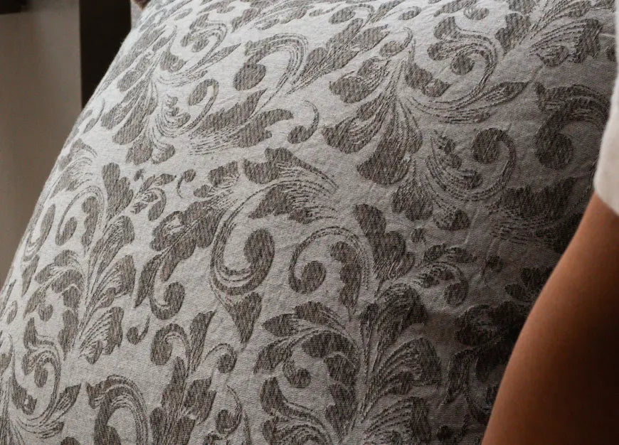 Close-up jacquard botanical fabric texture of premium decorative cushion cover