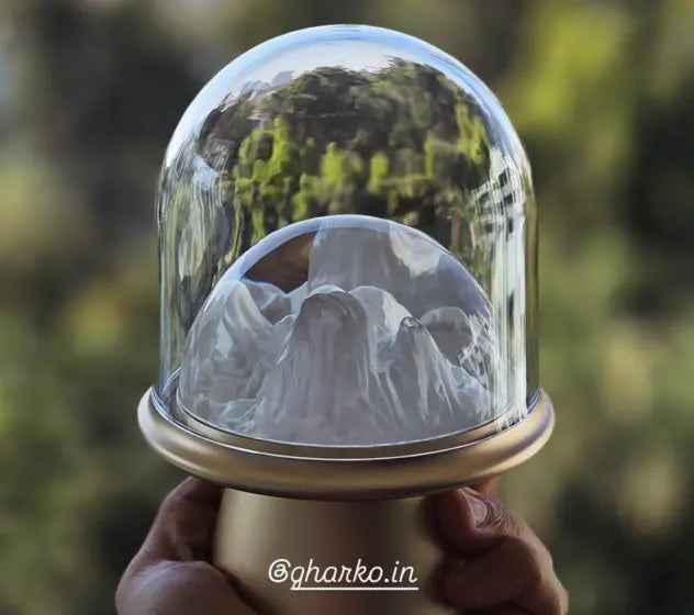 Frozen table lamp with sculpted like frozen ice held by a hand against a blurred natural background
