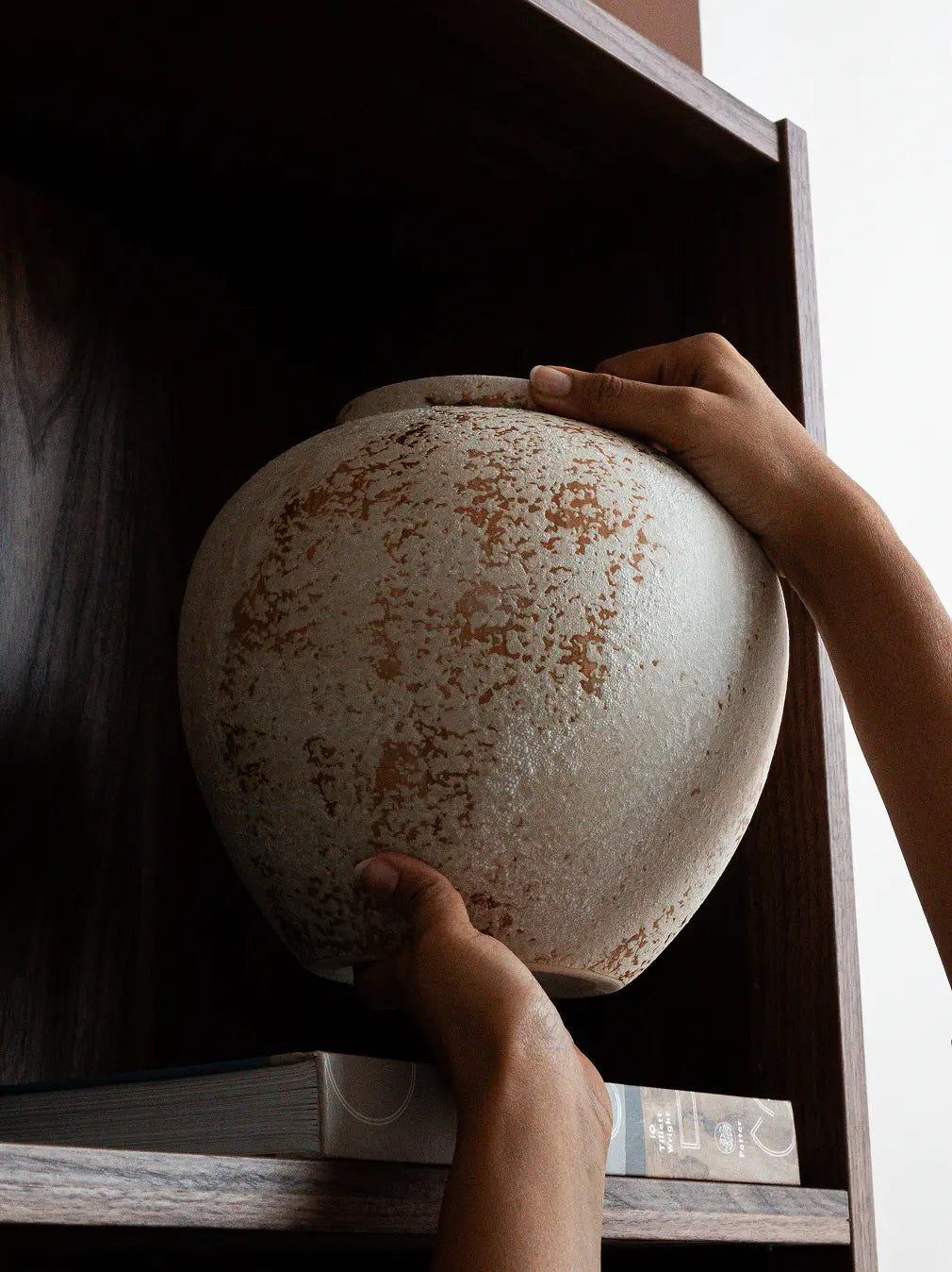 Handmade Gaia ceramic vase on wooden shelf with earthy textured finish