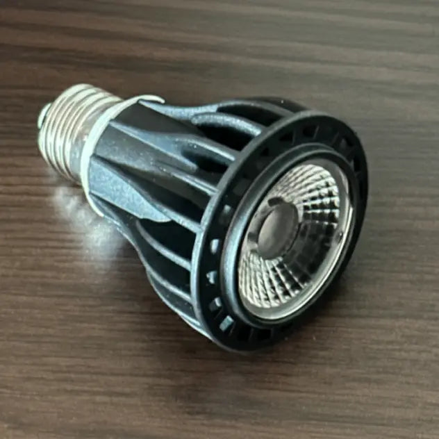 LED grow light bulb on a wooden surface