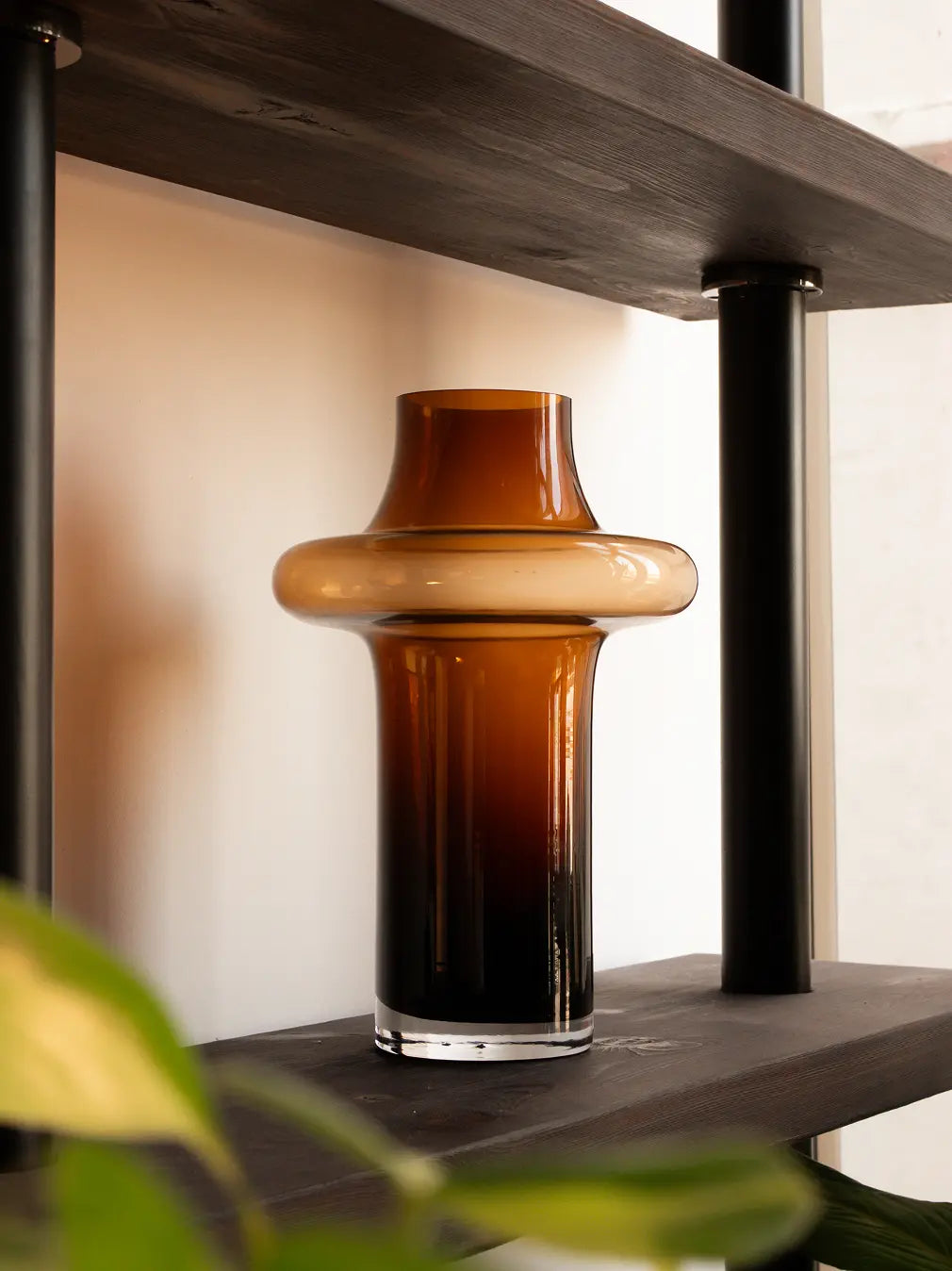 Halo Amber Glass Vase on dark wood shelf, tall amber glass vase for living room decor.