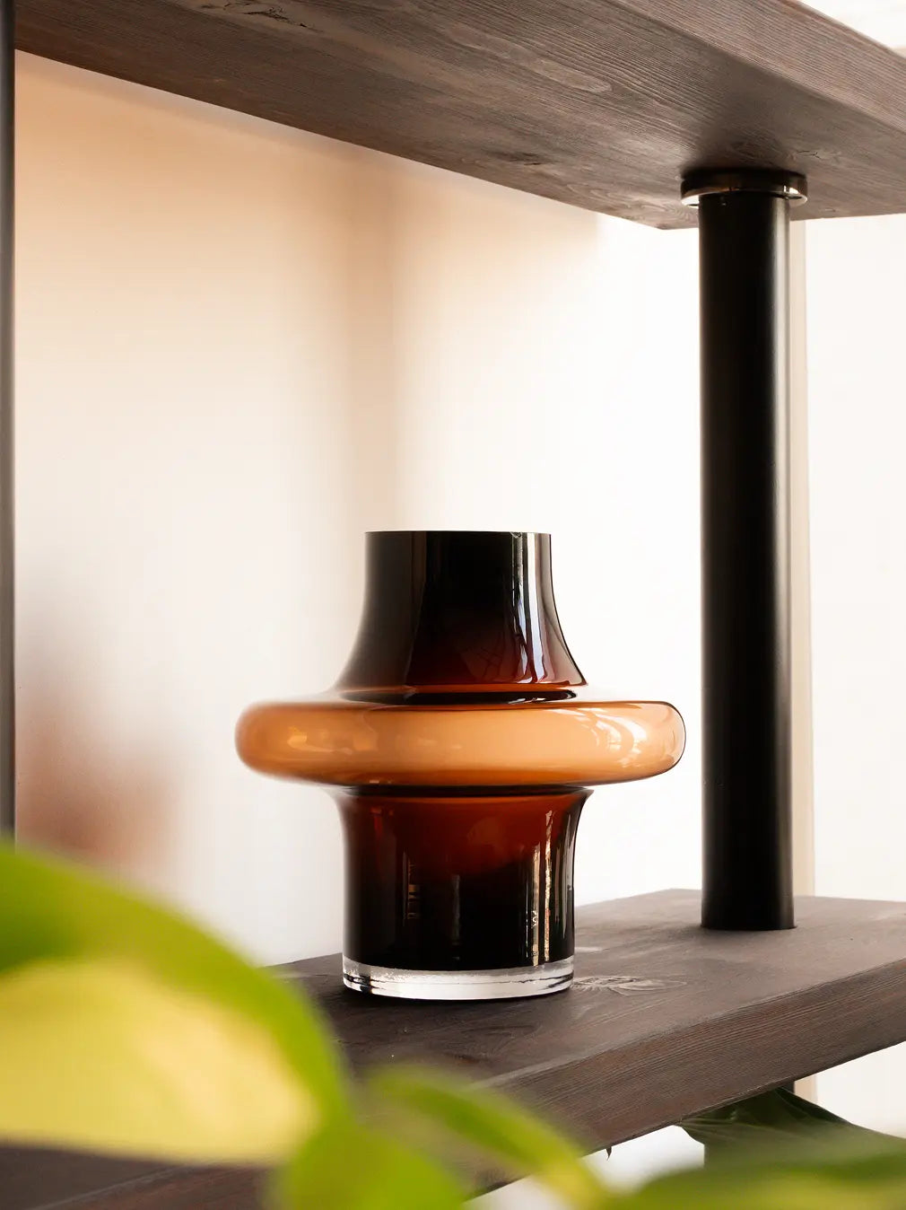 Person holding Halo Amber Glass Vase Small, modern amber glass vase with sculptural halo shape.