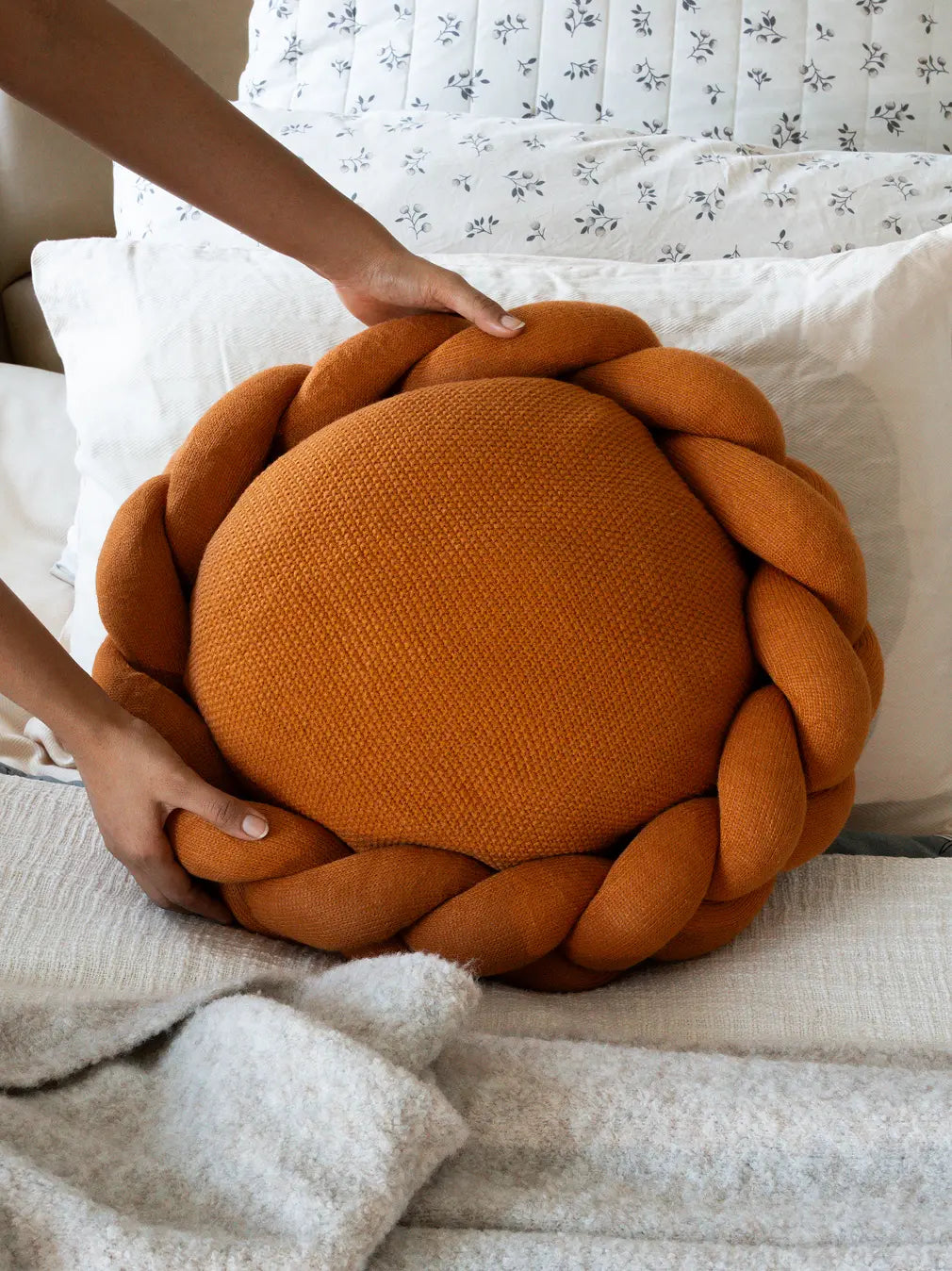 Halo Nest Cushion mustard with braided wool design styled on a bed for cozy home decor
