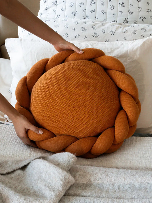 Halo Nest Cushion mustard with braided wool design styled on a bed for cozy home decor