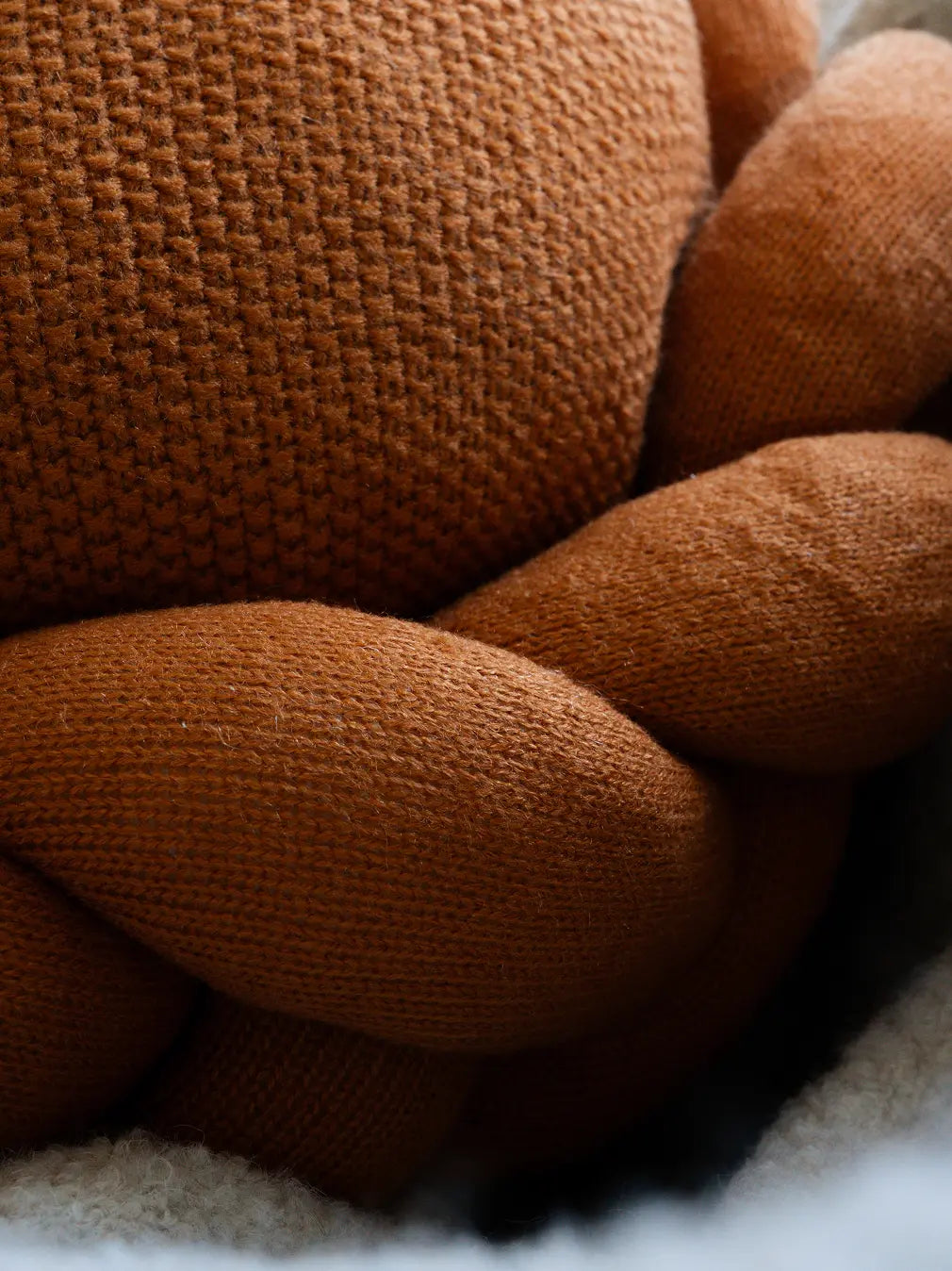 Close-up of Halo Nest Cushion braided knit texture in premium mustard wool
