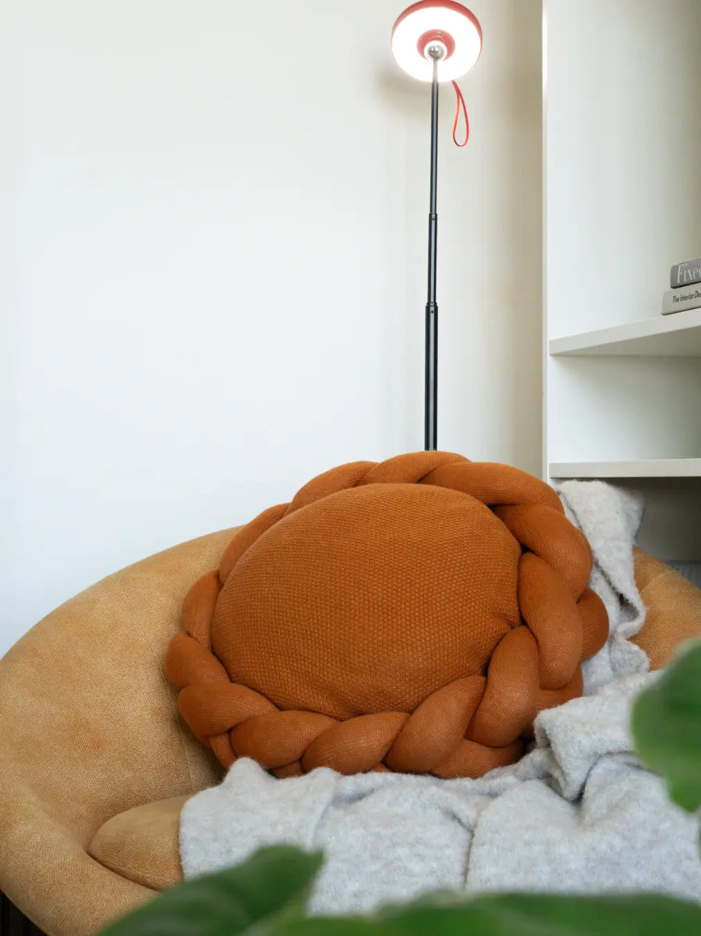 Modern mustard round cushion with woven wool texture styled in a minimal living space