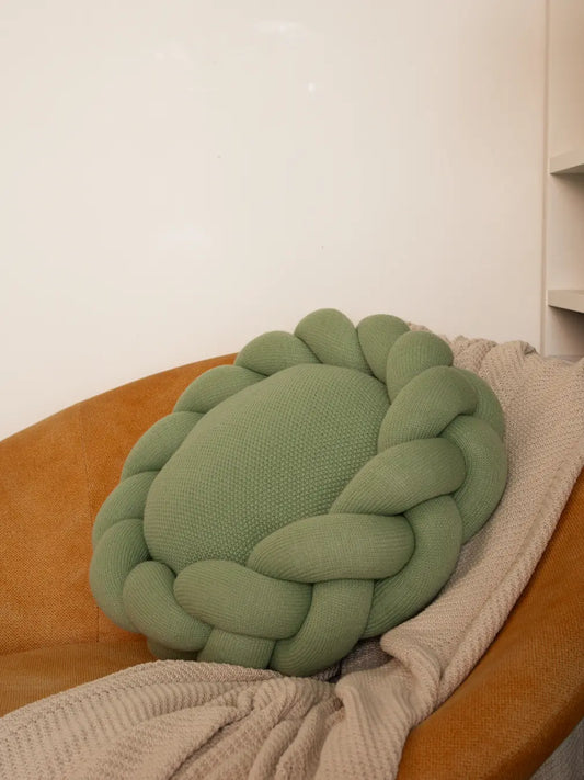 Halo Nest Cushion in Light green on chair – Gharko knitted round cushion