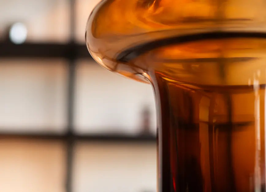 Detailed view of halo curve on Halo Amber Glass Vase, sculptural amber glass vase design.