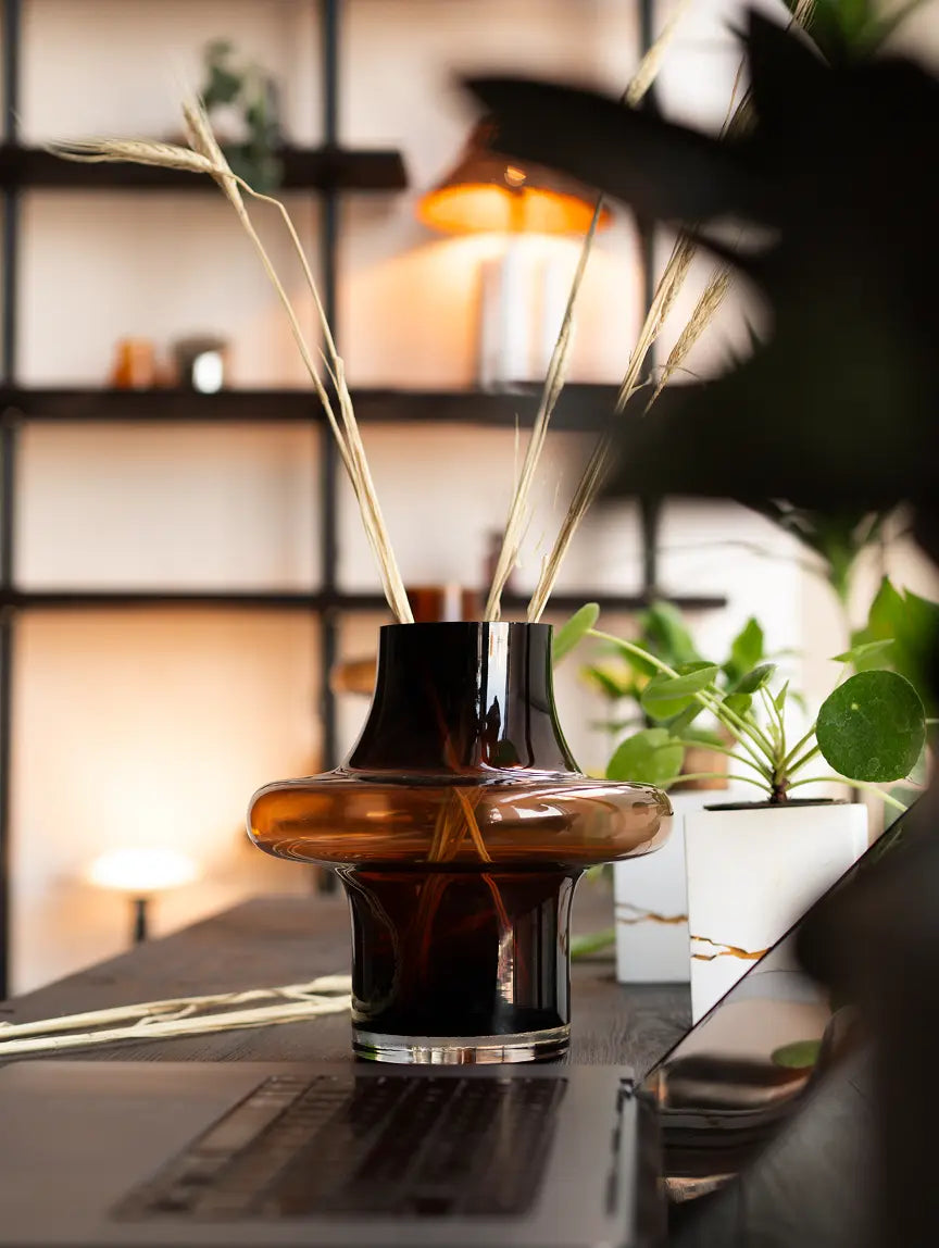Halo Amber Glass Vase Small on desk with dried stems and plants in a modern home office.