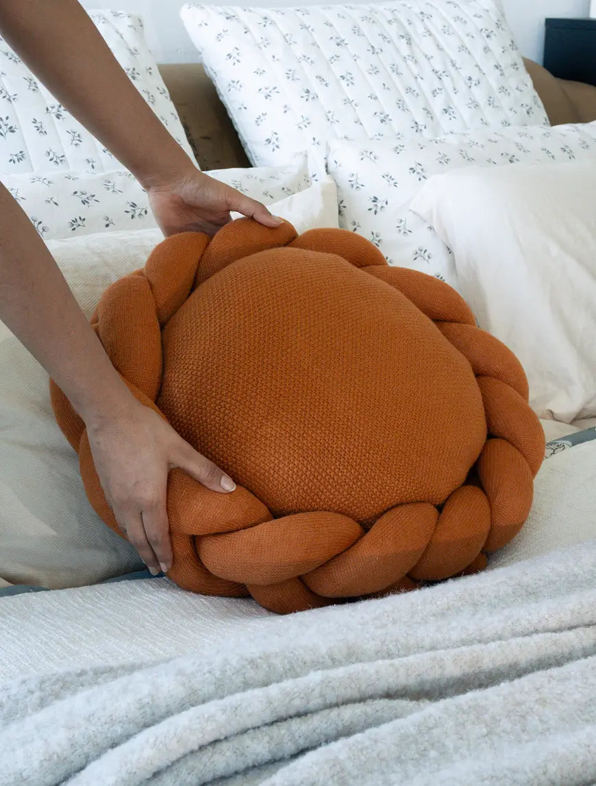 Mustard wool cushion with textured knit surface highlighting premium craftsmanship