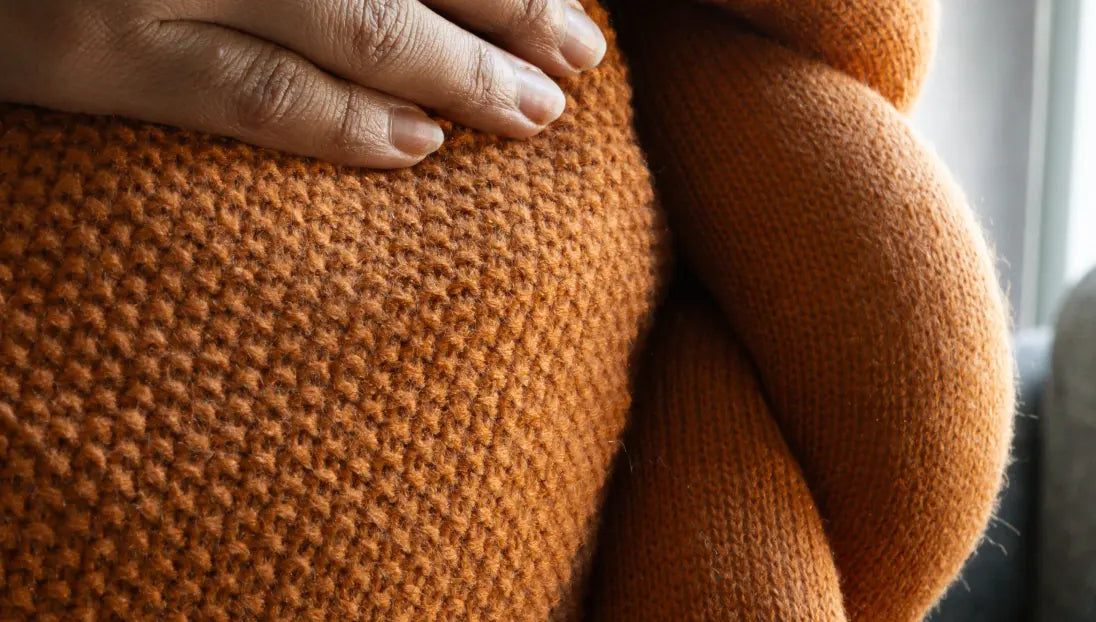 Detailed view of dense knitted wool texture on Halo Nest Cushion