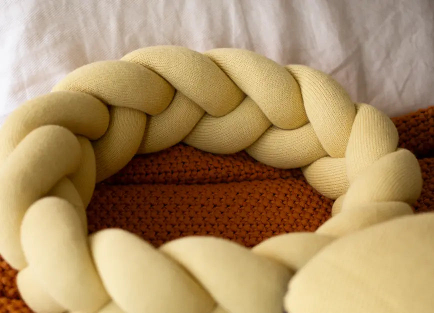 Halo Nest Cushion Yellow by Gharko showing braided knit ring detail in soft wool texture