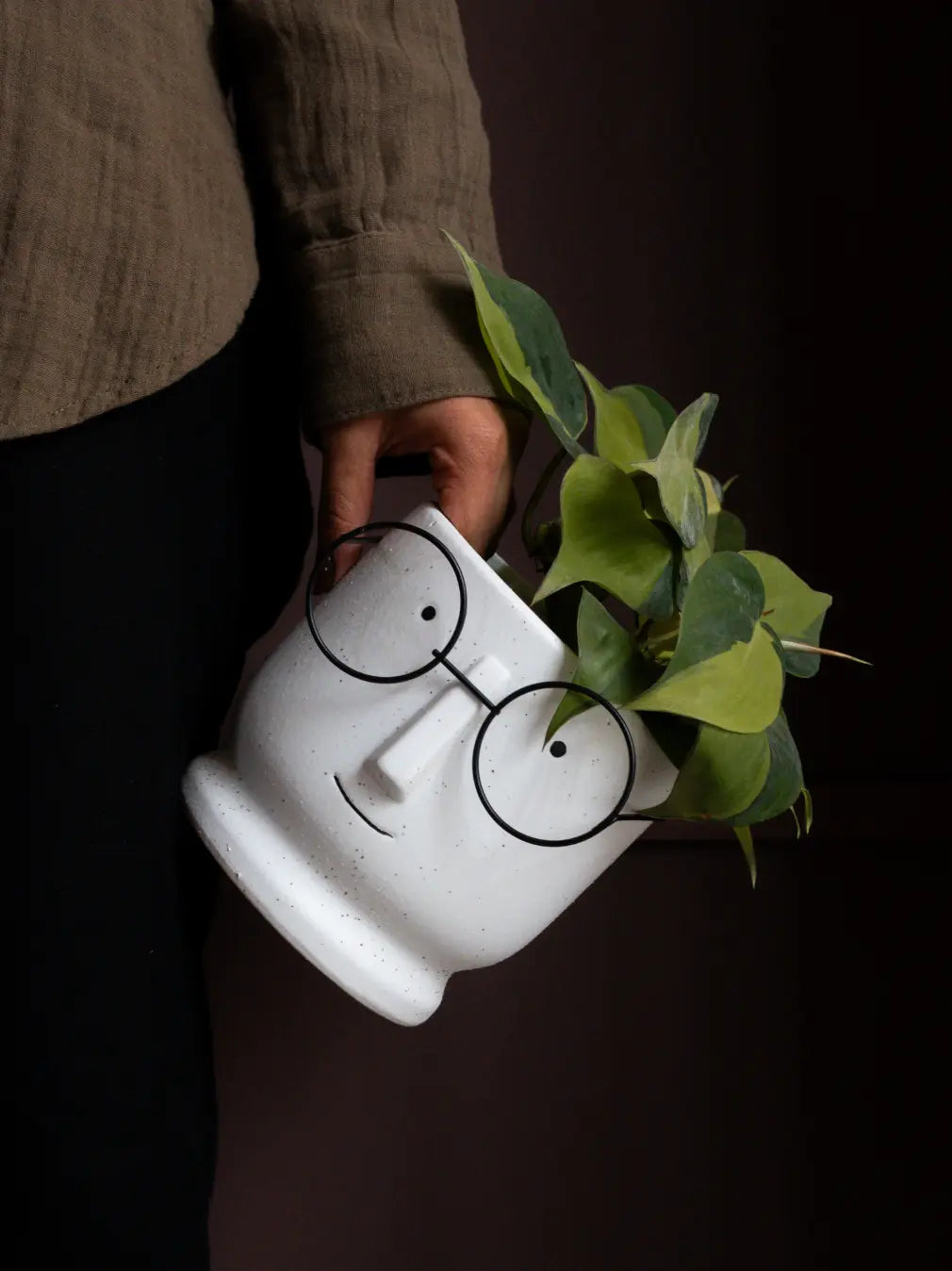 Jojo White Ceramic Planter with sculpted face and metal glasses, styled with green plant