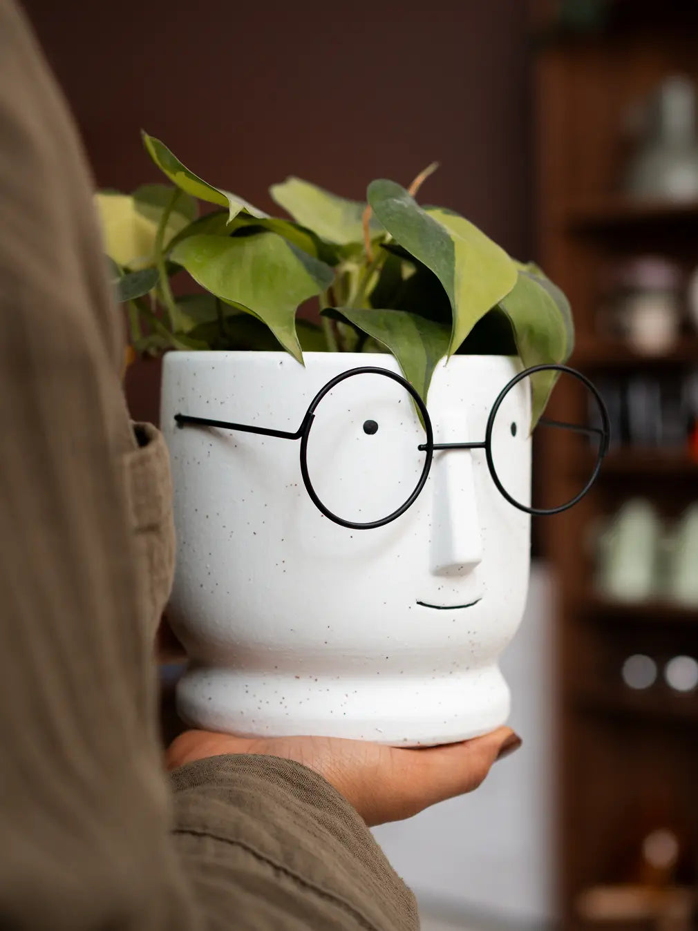 White ceramic face planter with metal glasses, ideal for indoor desk styling