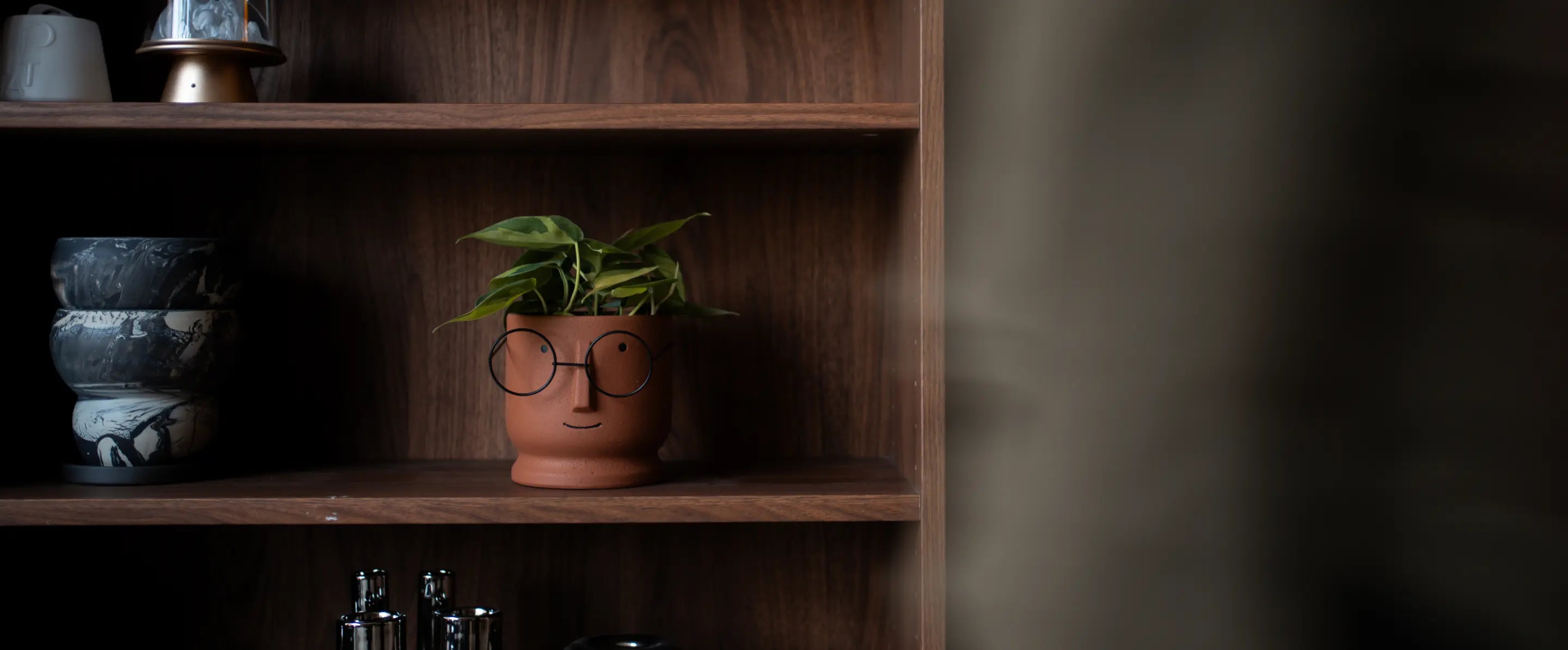 Wide view of Jojo Brown ceramic planters styled together in a modern interior setting